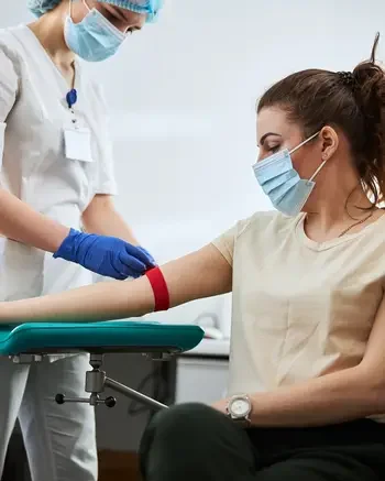 Phlebotomist taking blood from a patient