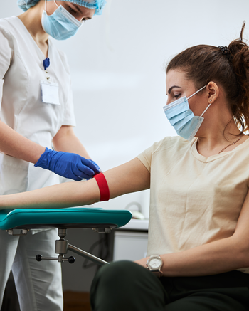 Phlebotomist taking blood from a patient
