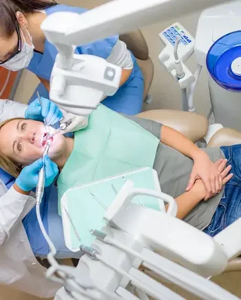 Looking down on patient with dentist and dental assistant