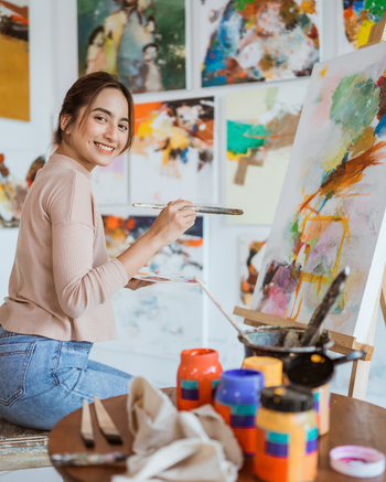Artist painting in studio