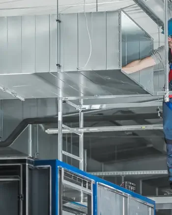 HVAC technician working on large HVAC system