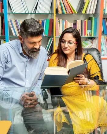 Two people reading in classroom or library