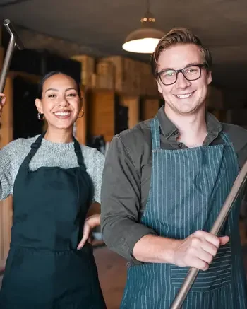 Two people holding fermentation tools
