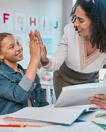 Sign Language interpreter working with a young student in a classroom