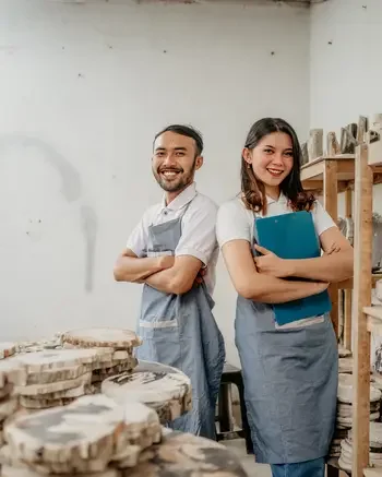 Two people standing in a workshop
