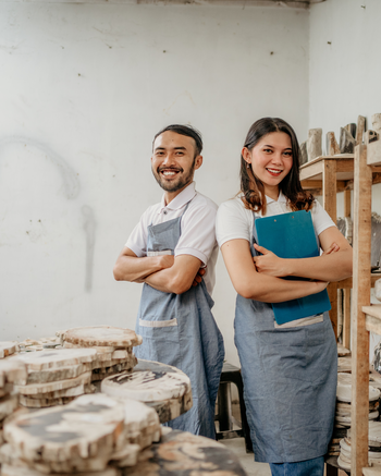 Two people standing in a workshop