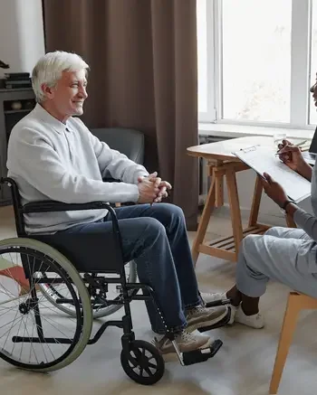 Practical Nurse working with patient in a wheelchair