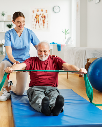 Physical Therapist Assistant helping a patient do exercises in clinic