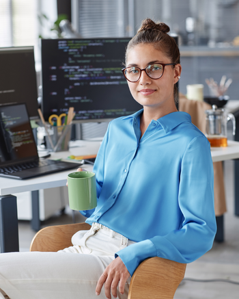 Women in front of desk with to monitors
