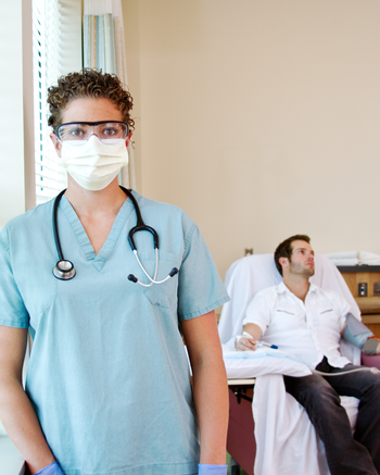 Hemodialysis Technician working with patient in clinic