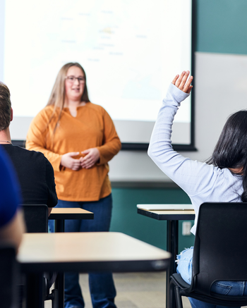 Teacher in front of classroom.