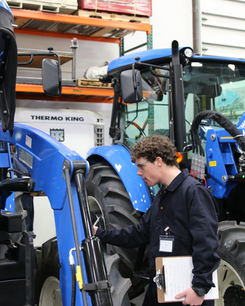 Heavy Equipment Technician working on tracker