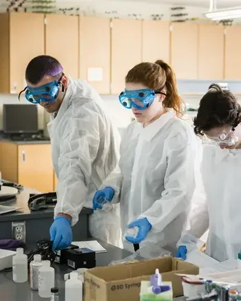 STEM instructor teaching students in a lab