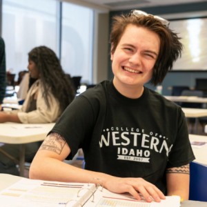 Student in classroom smiling at camera
