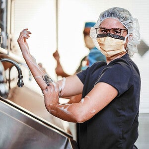 Healthcare studens washing hands in lab