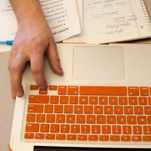 Hand typing on a computer keyboard