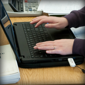 Hands on keyboard of laptop