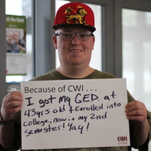 GED student holding written testimonial and smiling