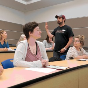 student in classroom for New Student Orientation presentation
