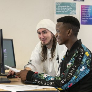 Two students sitting at a computer together