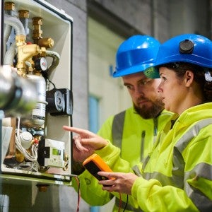 Plumbing apprentice learning on the job.