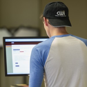 Student filling out online application on a desktop computer