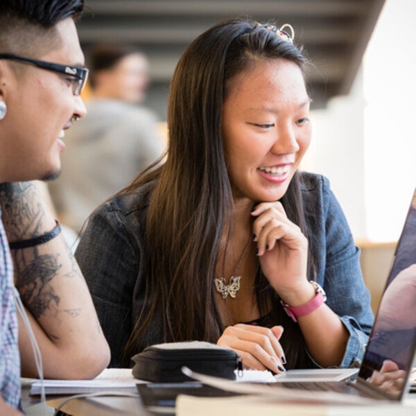Students reading news on laptops