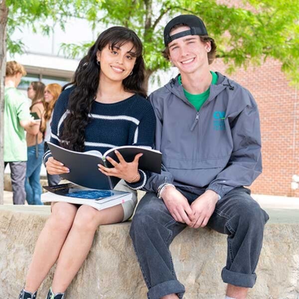 Students sitting outside the Academic Building