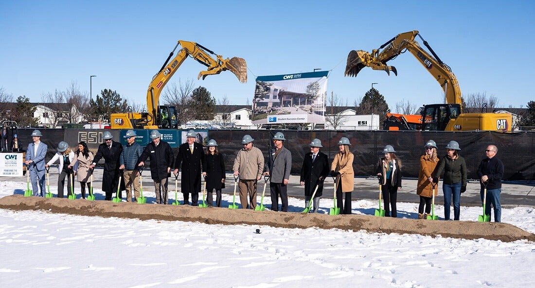 Dignitaries stand with shovels for a ceremonial groundbreaking.
