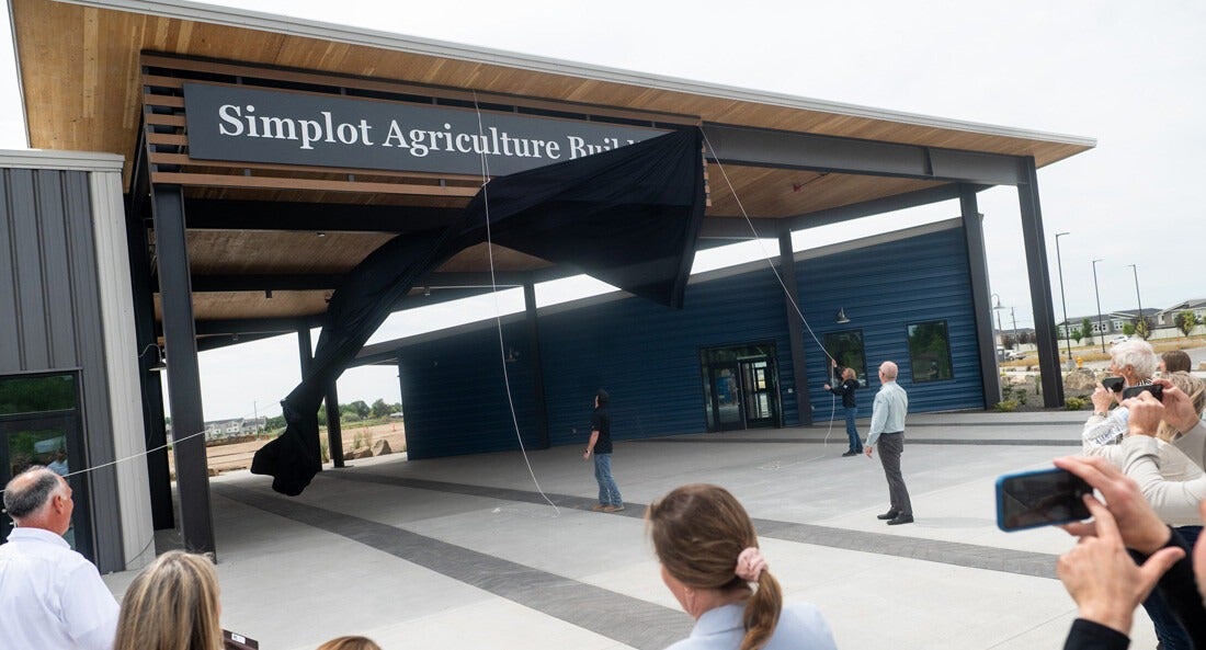 A new sign is unveiled on a building.