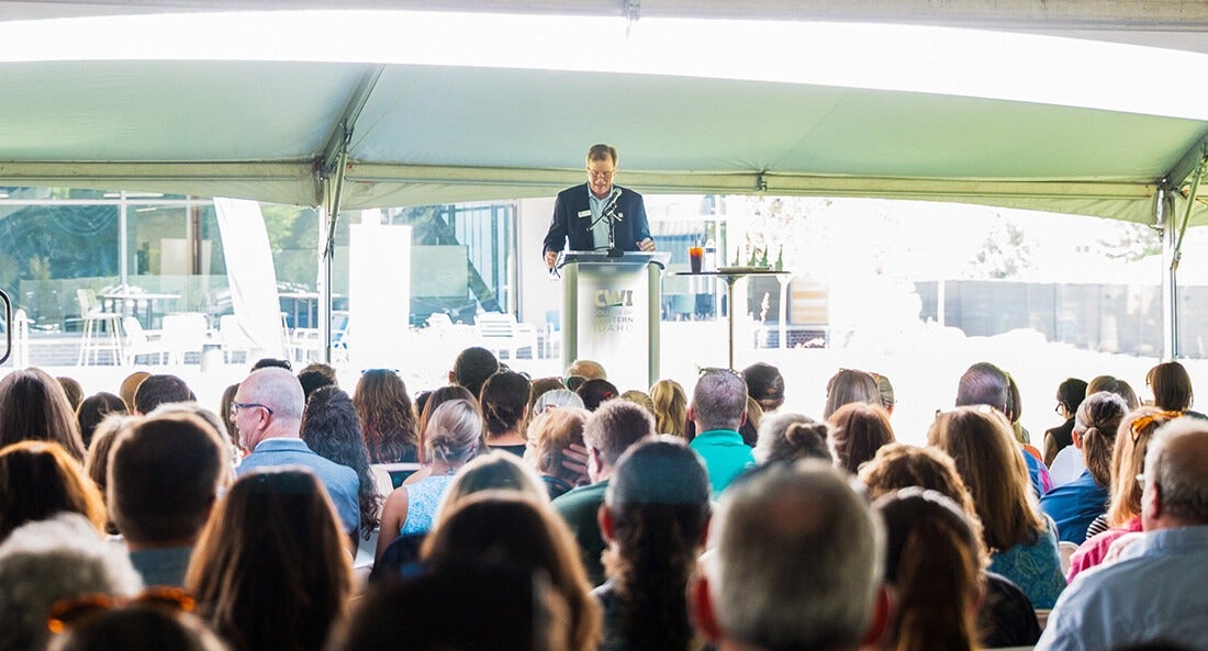 An audience listens to President Gordon Jones during the 2025 State of the College address.