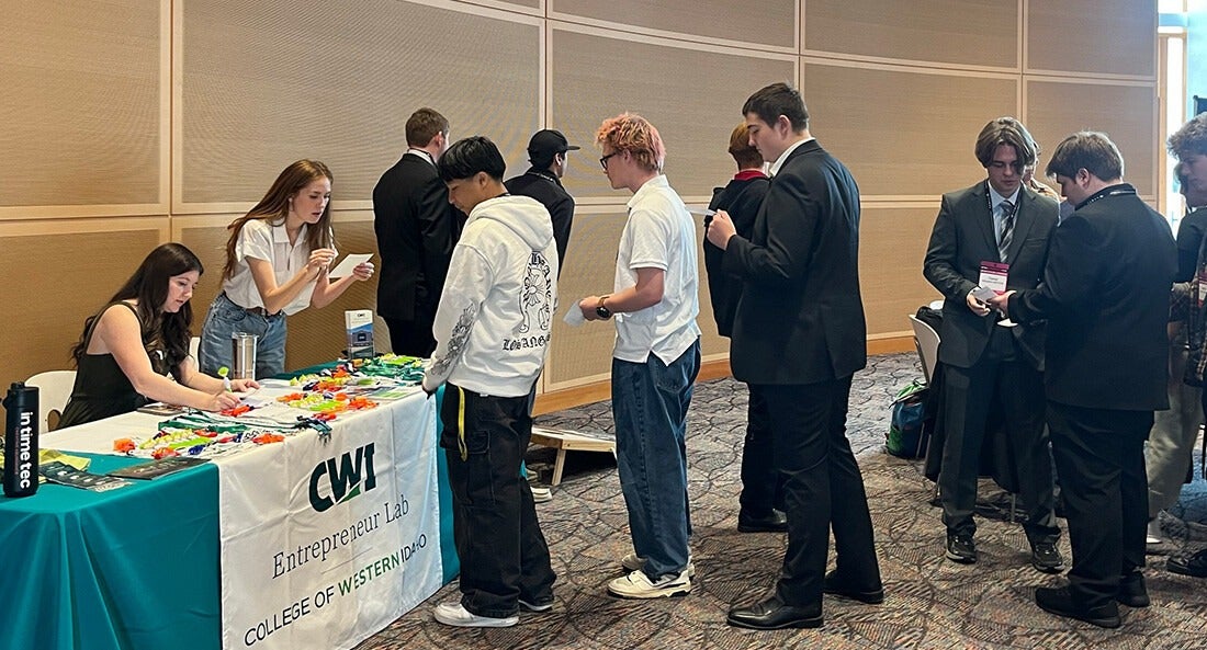 Students line up to register at an entrepreneur week table.