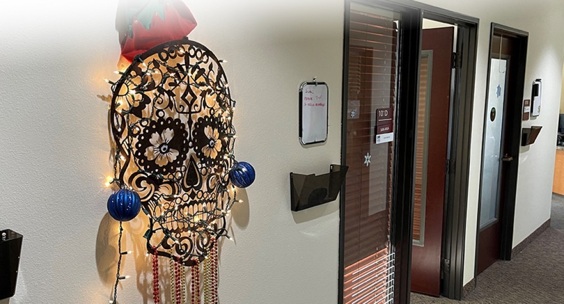 Sugar skull metal wall art decorated for Christmas and displayed in the HR office 