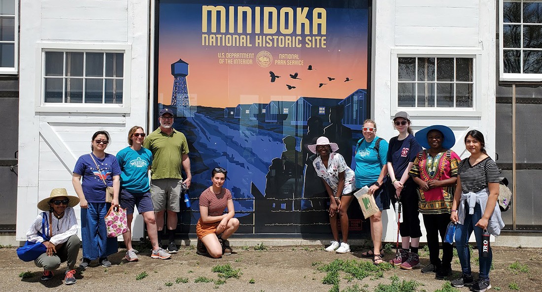 International Club members posing for a photo at the Minidoka National Historic Site sign
