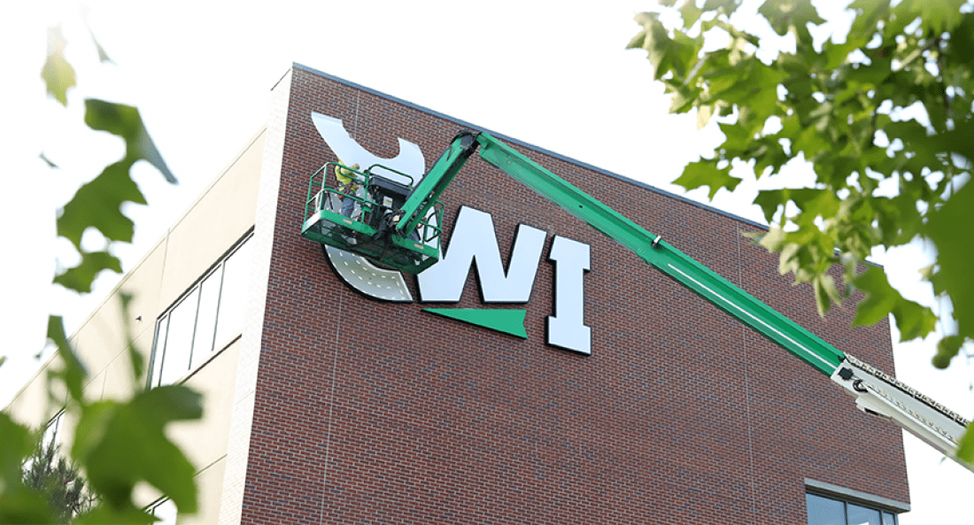 CWI’s new logo being installed on the outside of the Nampa Campus Academic Building