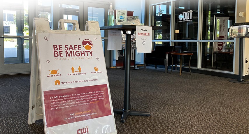 Be Safe, Be Mighty sign and sanitizing station on campus