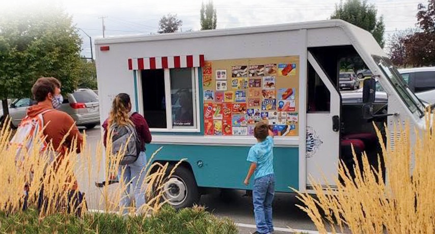 Students visiting an ice cream truck parked on campus