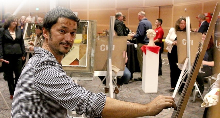 Goran Fazil, Studio Art faculty, works during the Opening Doors Benefit Event.