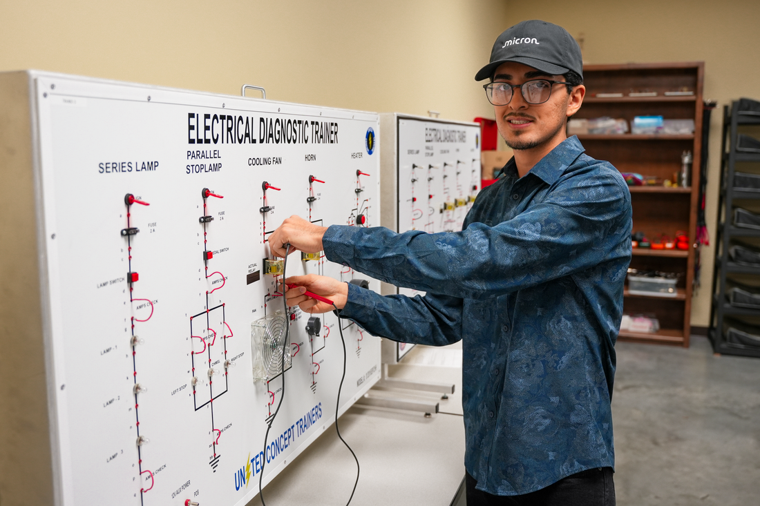 Student at board with wires 