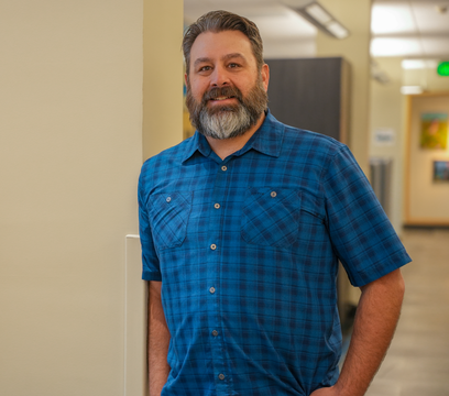 Person stands next to pillar and table