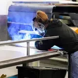 Student welding during class