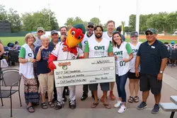 Humphrey the Hawk presents a check to CWI leadership, donors, and Board members for the SCORE Big Scholarship