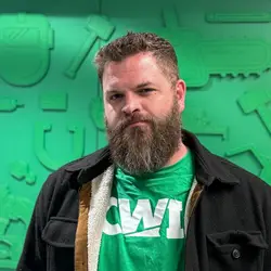 Man in front of green backdrop